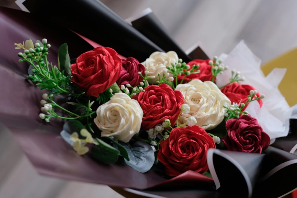 pexels-photo-15290971-15290971 Beautiful close-up of a red and white rose bouquet with greenery.